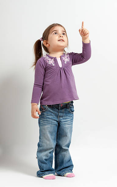 istock Cute little girl pointing up 469816140