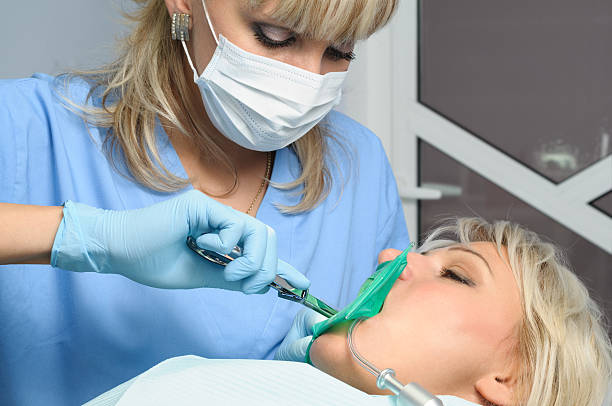 istock dentist with patient, installation of rubber dam 469816260