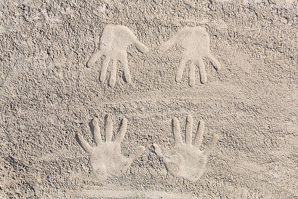 istock four hands footprint in the sand at the beach 469816418