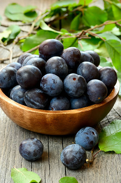 istock Plums in wooden bowl 469816693
