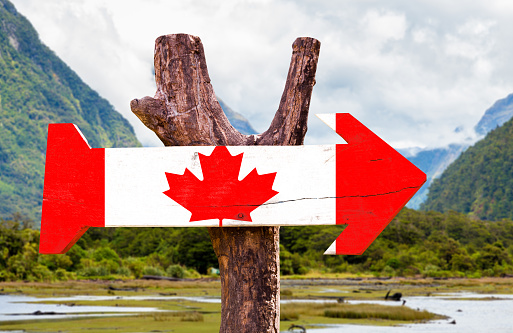 Canada wooden sign with mountains background