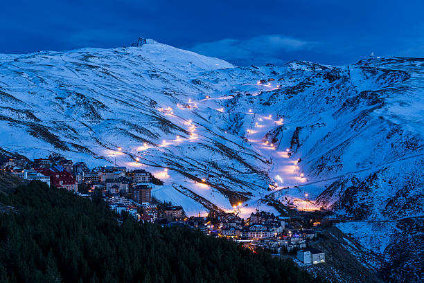 Lights at night in snowy hills in Sierra Nevada Pradollano area, Sierra Nevada National Park, Granada, Andalusia, Spain. granada spain stock pictures, royalty-free photos & images
