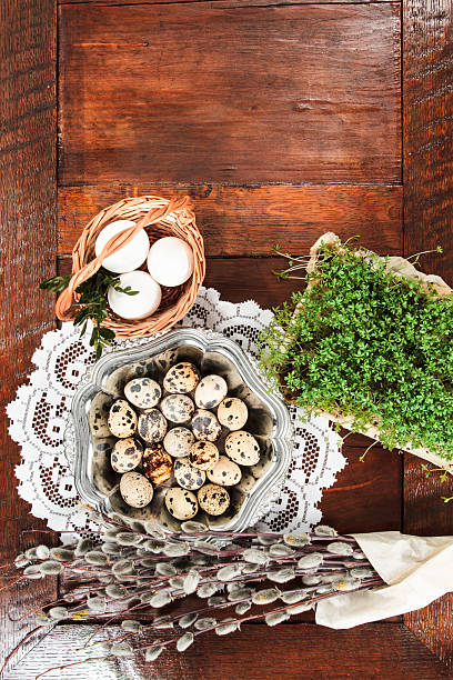 Easter composition of catkins, eggs and cress on wooden table