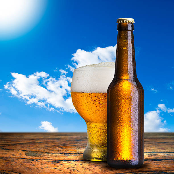 istock Glass of cold beer on wood table 469820157