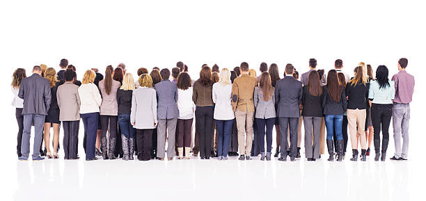 Rear view of crowd of business people isolated on white. Rear view of large group of business people standing together. Isolated on white. rear view stock pictures, royalty-free photos & images