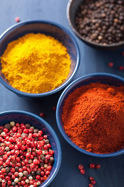 istock spices in bowls: curry pink and black pepper paprika powder 469823713