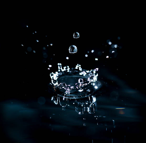 istock brilliant drops transparent water on black background 469823957
