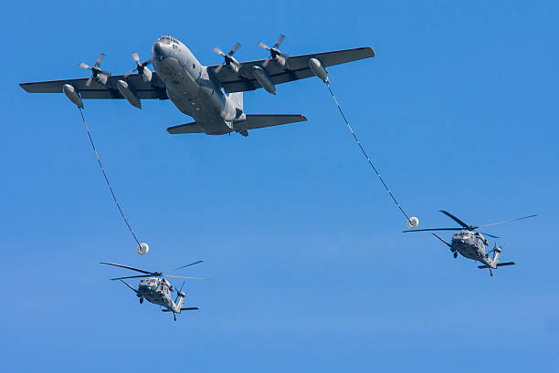 istock C-130 Hercules Refueling Two HH-60G Pave Hawk Helicopters 469824455