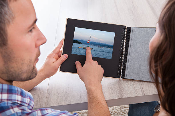 istock Young Man Pointing On Photo Album 469825695