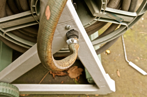 Bent old hose connected to portable reel