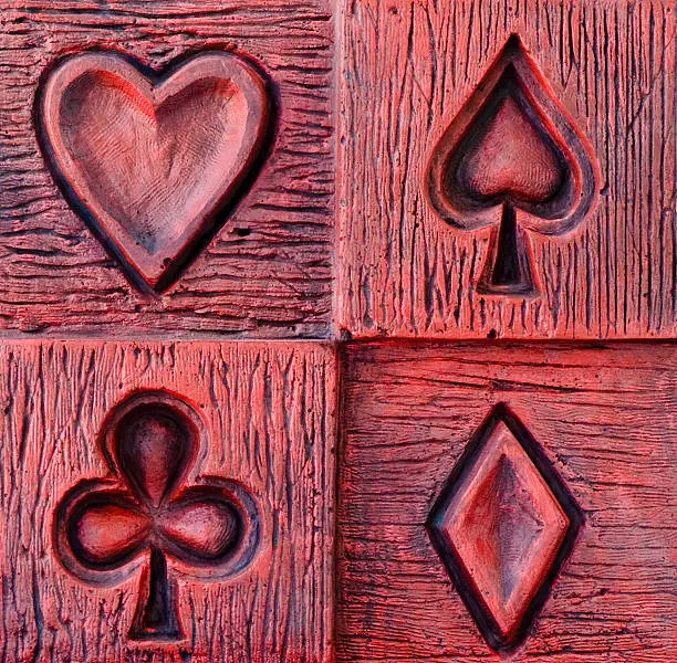 Ornamental cladding wall depicting symbols of playing cards