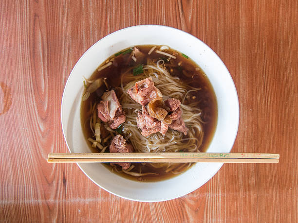 istock Thai Noodle Soup with Meat on wood table 469829249