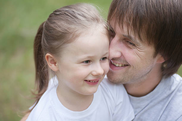 istock Smiling Father Cuddling Daughter 469830273