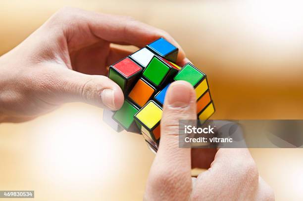Hands Playing A Cube Game Stock Photo - Download Image Now - Puzzle Cube, Solution, Cube Shape