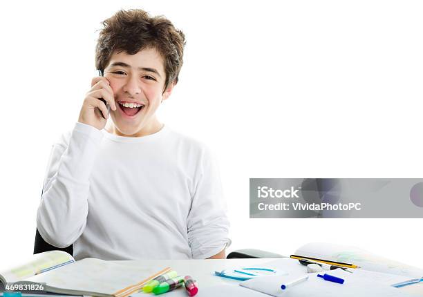 Caucasian Smoothskinned Boy Talking On Cell Phone On Homeworks Stock Photo - Download Image Now