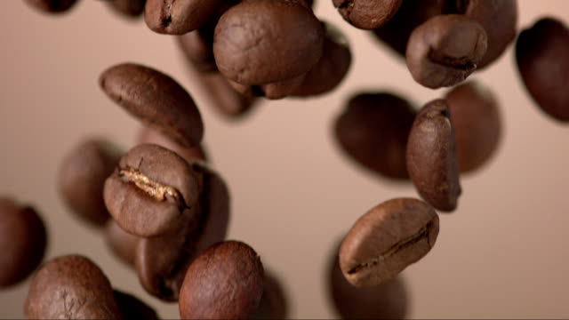 Coffee Beans Falling Over Background (Super Slow Motion)