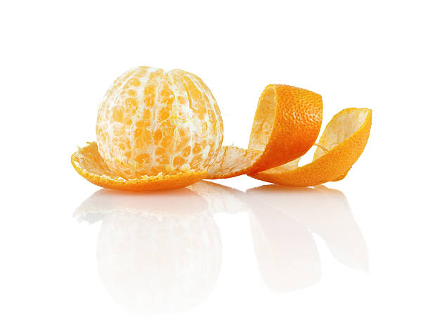 Peeled mandarin Delicious sweet juicy clementine. Peeled mandarin and peel on a white background with reflection. Isolated on white background. peeling food stock pictures, royalty-free photos & images