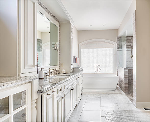 istock Large bathroom in luxury home with sink, bathtub, and cabinets 469838428
