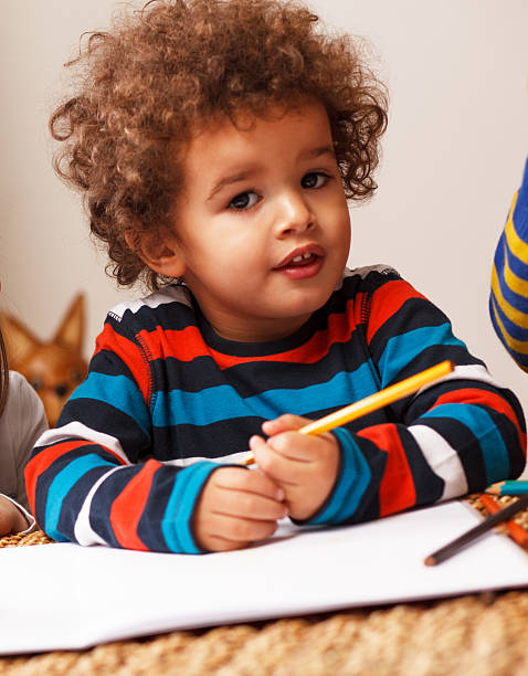 istock Young mixed race boy holding a pencil 469840393