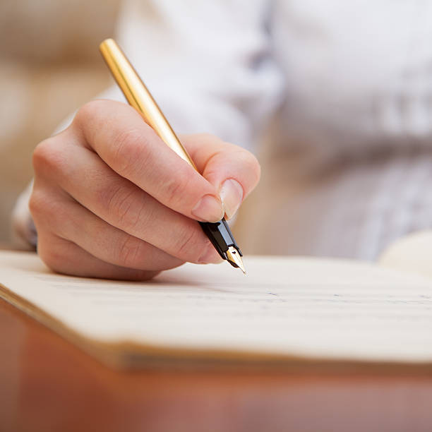 istock Hand with pen and music sheet 469840579