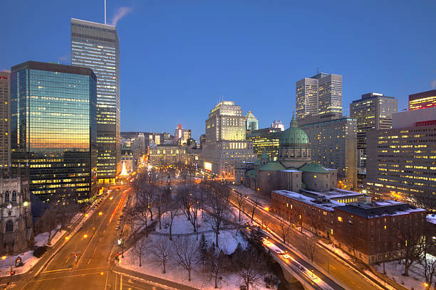 Downtown Montreal skycrapers reflecting sunrise Montreal, Quebec skyscrapers reflecting sunrise in panoramic view of downtown Place du Canada, covered in snow mary queen of the world cathedral stock pictures, royalty-free photos & images