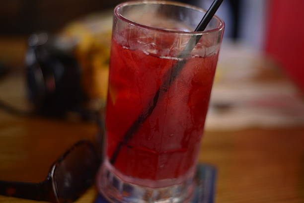 istock red liquid in glass with straw 469842554