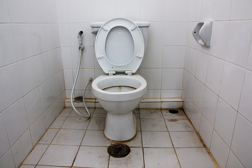 Dirty toilet with unpleasant stain