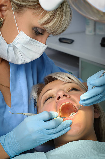 istock dentist with patient, dental calculus removal 469843784