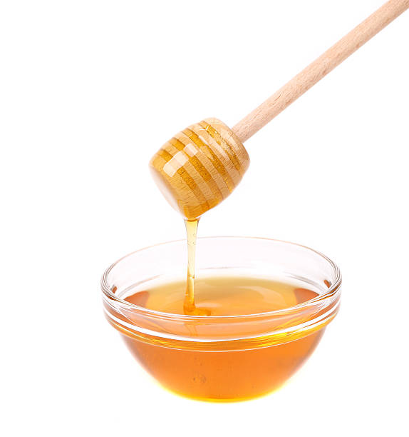 istock Honey dripping from a wooden dipper 469845341