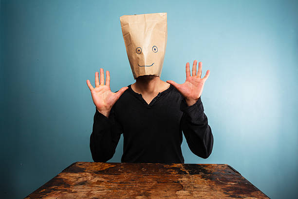 istock Stupid man with bag over his head and hands up 469845543