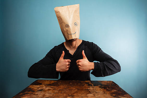 istock Man with bag over head giving thumbs up 469845721