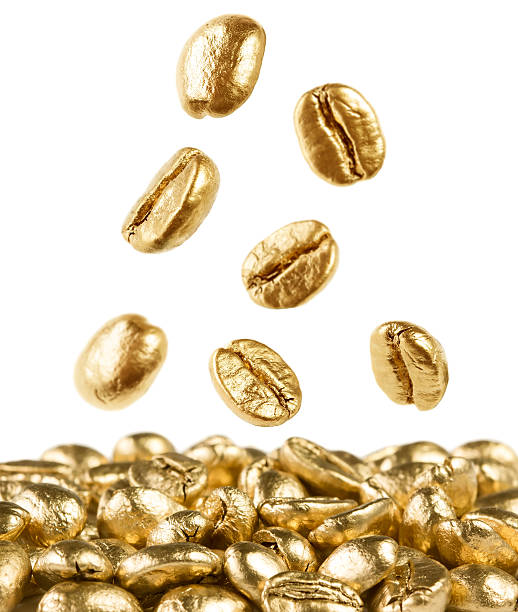 Gold coffee beans falling down stock photo