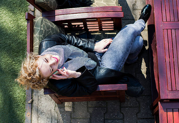 istock Young curly blond woman talking on the phone in cafe 469854902