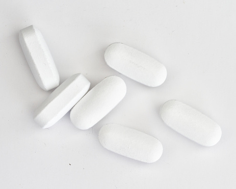 Medicine tablets isolated on a white background. White pills, containing a medicine