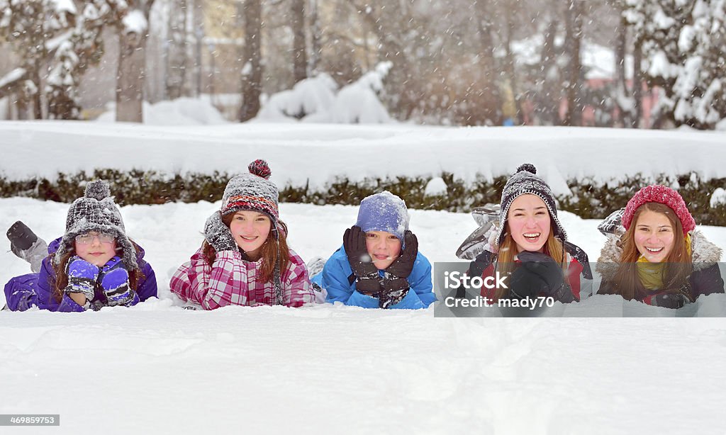 children on snow in winter time Group of children playing on snow in winter time Boys Stock Photo