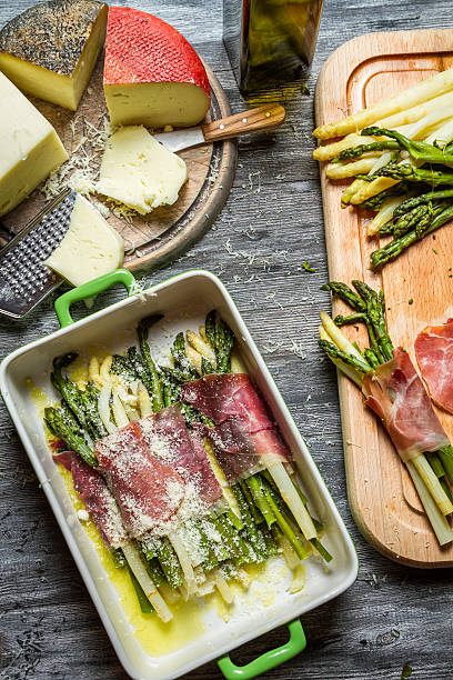 istock Asparagus wrapped in Parma ham with cheese 469863165