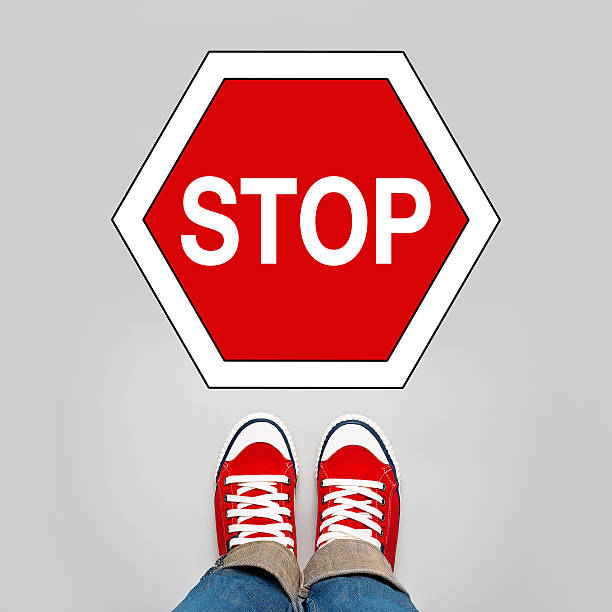 istock Stop Concept, Person Standing in Front of Sign 469864510