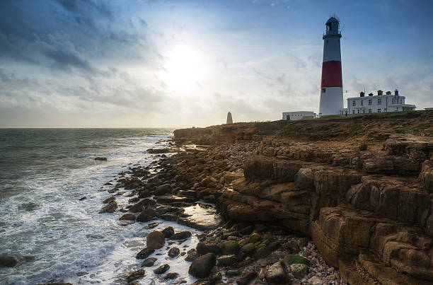 istock Landscape of waves crashing onto rocks around lighthouse 469865263