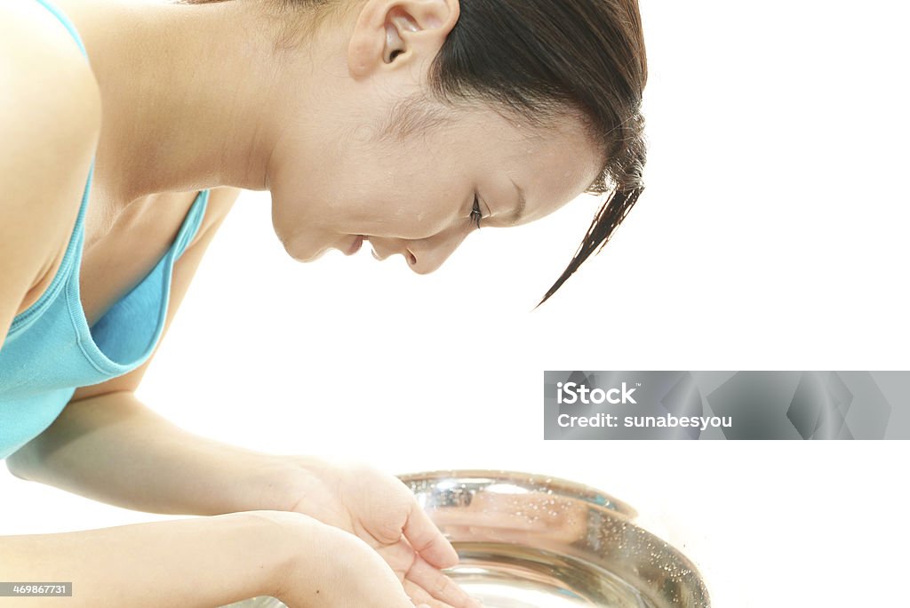 Woman washing her face Woman washing her face isolated on white background Wash Bowl Stock Photo