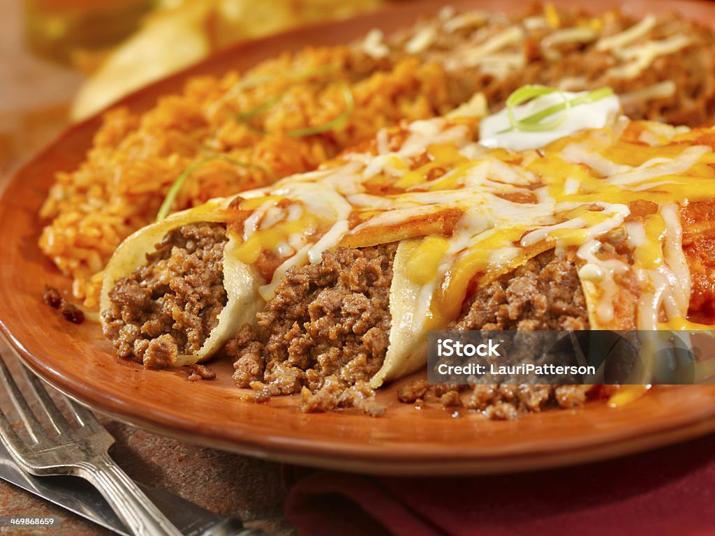 Entomadas or Beef Enchiladas Authentic Mexican Beef Enchiladas with Fresh Tomato Sauce, Sour Cream and Melted Cheese - Photographed on Hasselblad H3D2-39mb Camera Enchilada Stock Photo