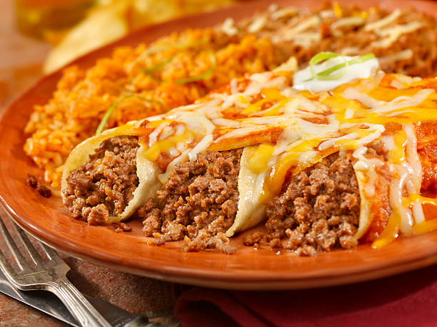 Entomadas or Beef Enchiladas Authentic Mexican Beef Enchiladas with Fresh Tomato Sauce, Sour Cream and Melted Cheese - Photographed on Hasselblad H3D2-39mb Camera enchilada stock pictures, royalty-free photos & images