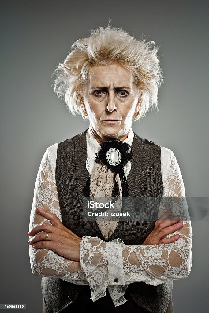 Crazy countess Contemporary portrait of victorian style countess looking at camera with angry expression. Studio shot. Senior Women Stock Photo