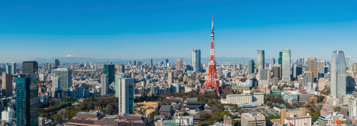 The snow capped summit of Mt. Fuji overlooking the iconic spire of Tokyo Tower, Roppongi Hills and the skyscrapers of Shibuya and Shinjuku in this aerial panoramic vista across Japan's crowded and vibrant capital city. ProPhoto RGB profile for maximum color fidelity and gamut.