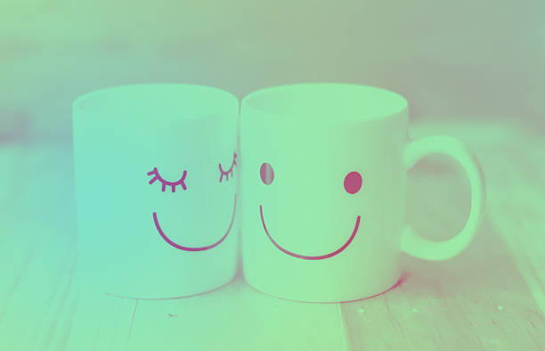 istock Two happy cups on wood table with bokeh, love concept 469869554
