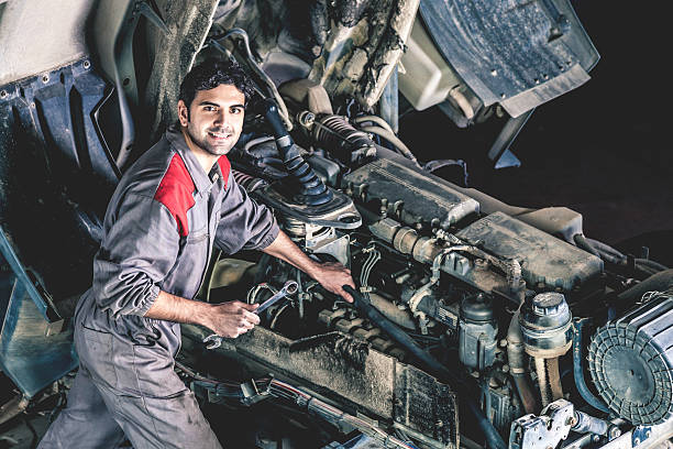 Mechanic working on a truck Auto and trucks mechanic working on a truck. car mechanic top view stock pictures, royalty-free photos & images