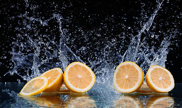 istock Sliced lemon in the water on black background 469872808