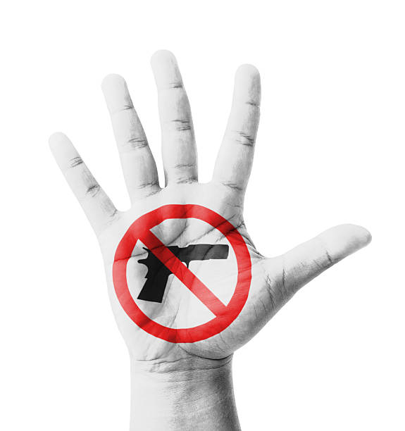 Open hand raised, No Gun sign painted stock photo