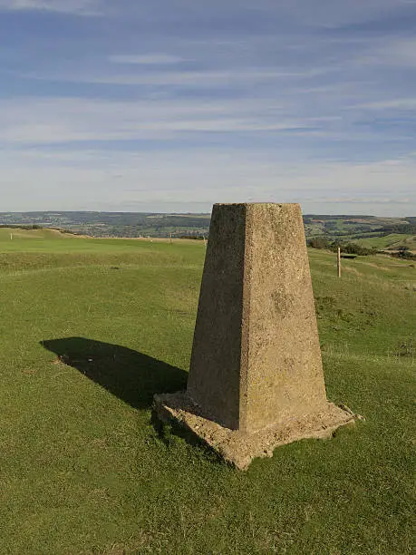 ordnance survey triangulation column on the summit of cleeve hill, cotswolds, gloucestershire, uk