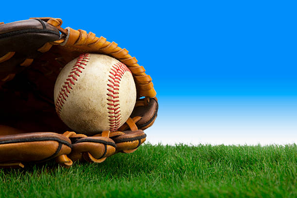 guanto da baseball e su campo in erba - baseballs baseball grass sky foto e immagini stock