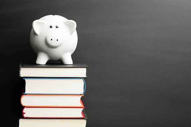 istock Back to School - Piggy Bank Finance Blackboard  Books Stack 469879147